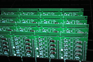 Four small batch circuit boards lined up